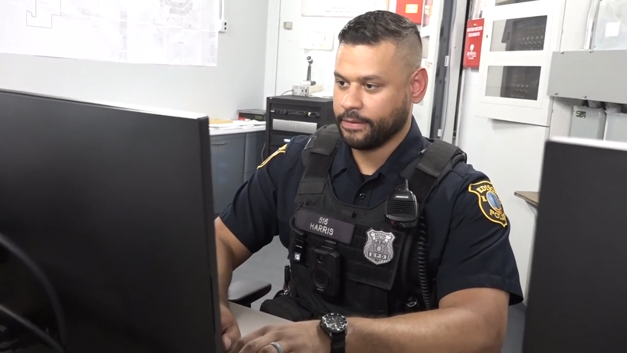 A police officer works inside the Edison police substation at Menlo Park Mall. EDISON TV/Video